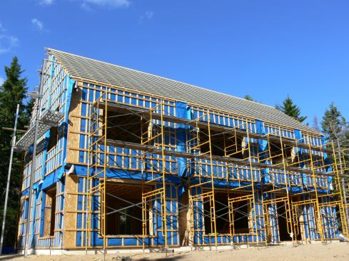A view from the ground shows the completed roof strapping system.