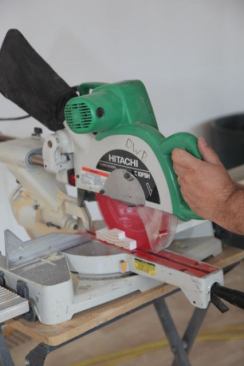 With the photo zoomed all the way in the focus is on the action of sawing that particular leg of the jamb.