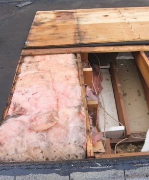 At the interface between the addition and the original attic, warm, moist air flowing through the batts in the cathedral ceiling had been condensing on the sheathing, rusting the nails and staining the plywood.
