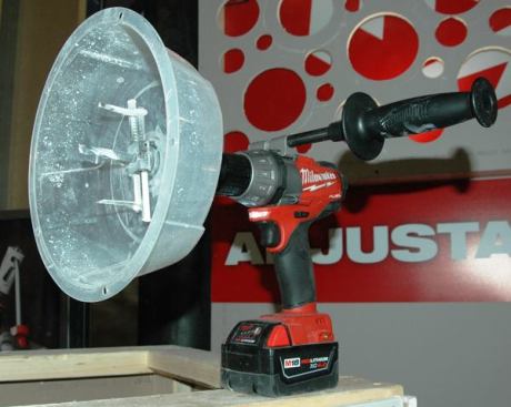 Adjustable Hole Cutter. This twin-bladed scoring cutter is for making circular holes in soft, nonstructural material such as drywall and ceiling tiles. The simple plastic debris shield is spring-loaded to keep it tight against the surface; the shield stays put while the bit spins freely inside. The hole size adjusts from two to seven inches in diameter in 1/4-inch increments and can be locked in place without the use of tools. 
Click here to see this tool in action.