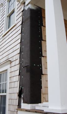 The shingles were held back for installation of the pilasters, which had to be scribed on two sides to the house corners.