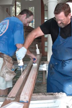 The author applies an even coat of glue to each lamination with a 2-inch roller.
