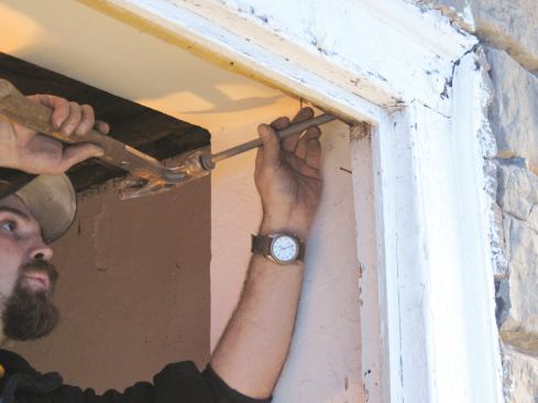 The author pounds out the peg securing the corner joint.