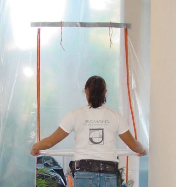 Stick-on zipper doors aren't very durable, but they’re inexpensive and easy to install, so the author uses them for lightly traveled passages. The cords taped to the poly above the zippered flap are used to tie the door in the open position.