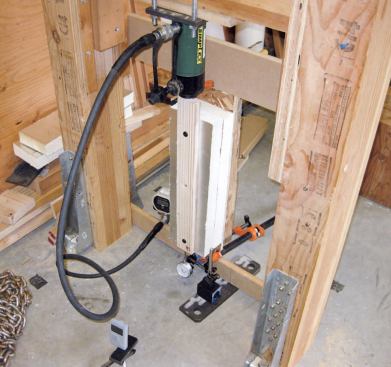The test assembly was a sturdy shop-built frame securely attached to the concrete floor with metal holddowns and concrete anchors. A hydraulic ram secured to a cross-member provided the measured force.