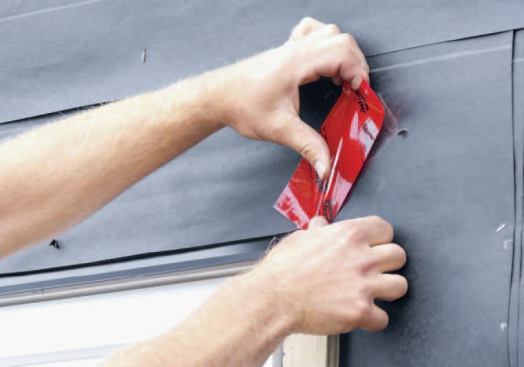 I fold the paper back down and patch the corner cuts with a flashing tape.