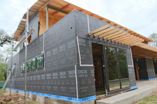 Delta Vent SA from Cosella-Dorken. This is a fully adhered housewrap so no staples visible here.