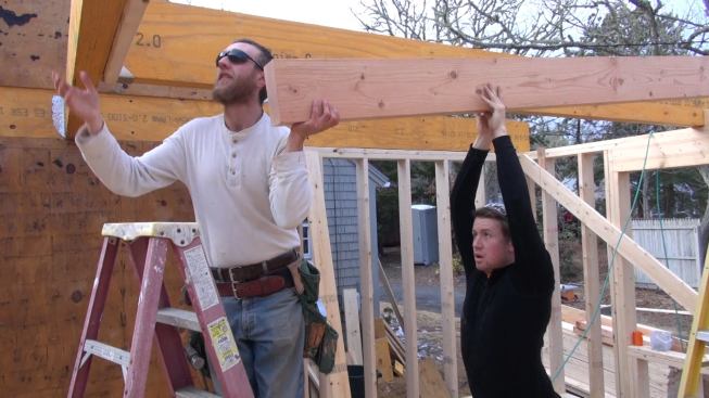 Hill and Laffin set a Doug Fir 4x8 floor joist in place.