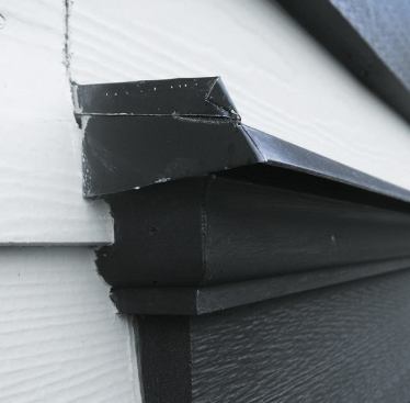 To prevent wicking, the siding gets held off the cap flashing by the height of the end dam.