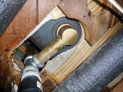 Floor openings around bathtub P-traps can leak as much air as an open window. They’re best closed off with a piece of polystyrene — notched on one edge to fit around the pipe — set in a fresh bead of canned foam.
