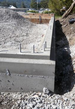 An excavated bed filled with crushed stone served as a base for the stemwall foundation, which was stepped down at its upper edge so that the exterior foam insulation wrapping the frame would cover the edge of the mudsill, eliminating a potential thermal bypass.