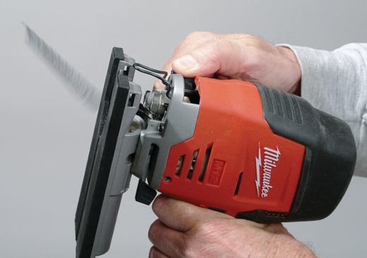 To install a blade, you move the spring-loaded lever up front, push the blade all the way in, and let go of the lever. Move the lever again, and the blade pops out, as shown here.