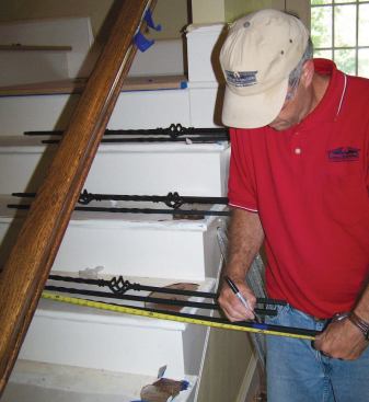 I add enough to the baluster's overall length so that the base will penetrate the tread by about 3/4 inch when the top is fully inserted into the handrail, and use a piece of masking tape wrapped around the base to help indicate my cut line.