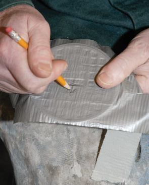 After covering the drain cap with duct tape to protect it, I marked the orientation with a pencil.