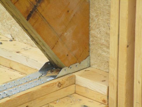 A view of the structural connection for the lower end of the double LVL rafter that forms one leg of the supporting truss that carries the home's LVL structural ridge beam.