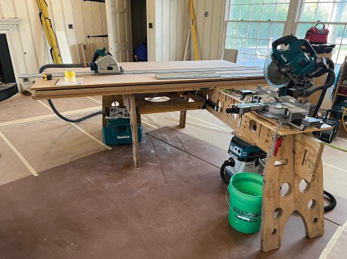 By removing the table saw and placing a piece of plywood over the top, the author creates a track-saw station or large assembly table. 