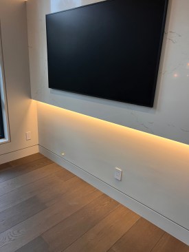 Here the lighting is installed to offset a stone television panel.