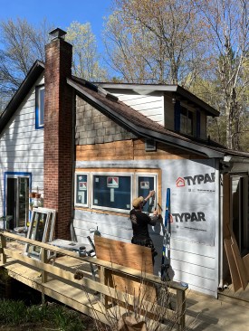 Final steps on the exterior included patching in new aluminum siding to match the existing and trimming out the new windows and door.