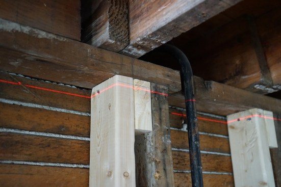 At the top of the wall section described above, the pencil line shows the position of a laser before jacking the beam in the basement. In this phot, the jacking ...