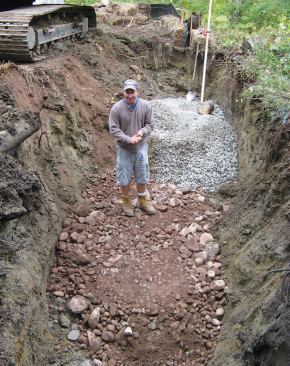 The contractor dug trenches for setting the concrete abutments.