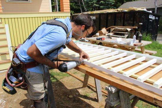 Pollard pins the top ends of the balusters to the sub-top-rail with three 15-gauge stainless steel nails.