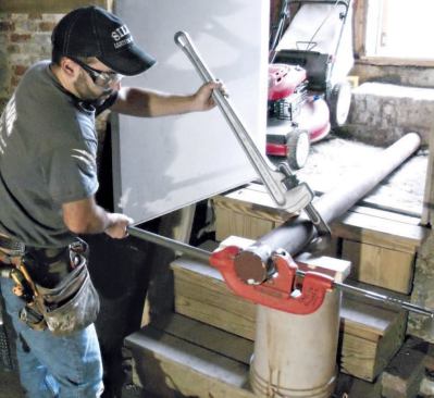 I prop the columns in a stable position (generally on horses, but here I used the basement stairs) and go to work with the cutter and pipe wrench.