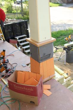 Here, a course of shingles has been nailed on over the MortairVent and a plinth, or "shingle base cap," as the crew terms it, has been applied at mid height.