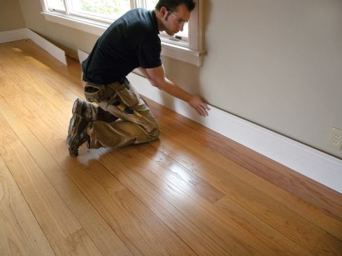 If a wall is longer than our baseboard stock, we splice sections together with biscuit-reinforced butt joints before setting the sections of baseboard in place to test the fit.
