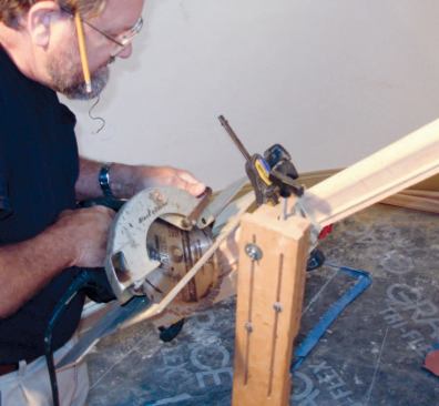 A shooting board fastened to 2x4s clamped to the handrail will help guide the cut, which is made in place with a circular saw.