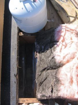 Along the addition's ridge, air leaking from inside had left a dirty deposit in the batt insulation.