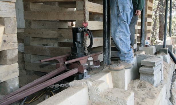 The drag bar counters the auger drill's torque.