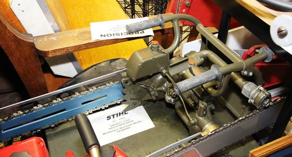 The olive green saw is a rare STIHL model from the 1950s, pneumatically powered and designed for use underwater.