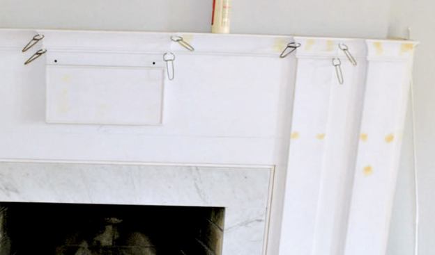 Coping was impossible for the detailed molding profiles, so I mitered inside corners. I started with the large cove molding at the top, then used gauge blocks cut to the width of the reveals to make sure the moldings below ran parallel.