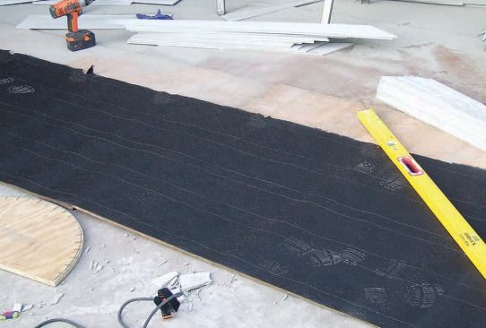 I laid tar paper across the template and cut it to size so that it would neatly fit the gable.