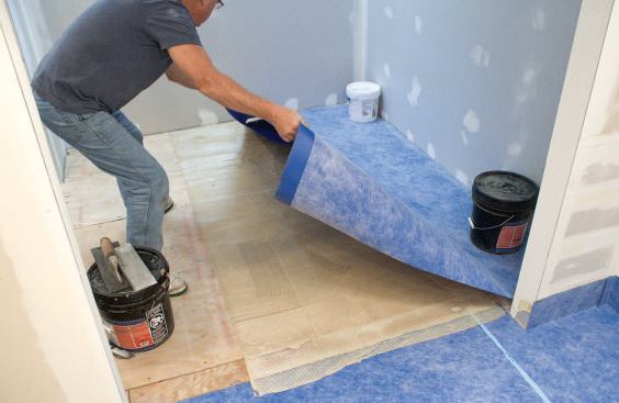 When the contact cement becomes tacky (which takes about 10 to 20 minutes), the author unfolds the loose end of the membrane.
