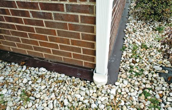 We also lined the trench with filter fabric and installed a 4-inch drainpipe that ran to daylight, before backfilling with clean 1-inch stone.