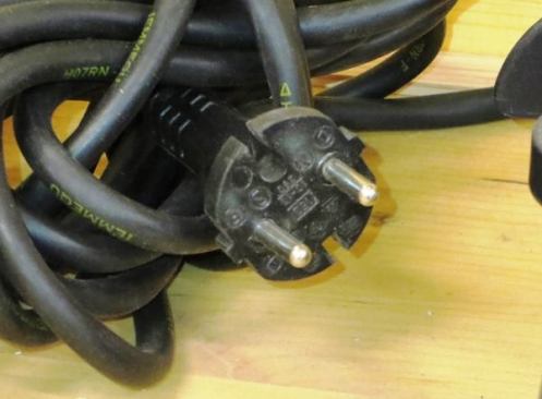 Every now and then I was reminded that the tools in the Festool museum would be hard to use here—as when I looked at the power plugs. Here we use 110 volt 60 cycle power; in most of Europe they use 220 volt 50 cycle power and the type of two-pin “Schuko” plug shown here. This particular plug is not grounded, but most are. The ground connection is made through a pin that extends from a recessed receptacle (all the ones I saw were recessed) into the plug or via spring-loaded contacts in the sides of the plug and receptacle.
