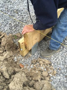 Because the four-ply beams were too wide to fit into the 6 1/8-inch wide U-shaped brackets on top of the helical piles, 1/8-inch deep mortises needed to be routed at the ends of each beam.