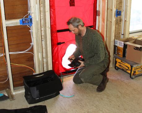 Harvey Johnson sets up the blower door.