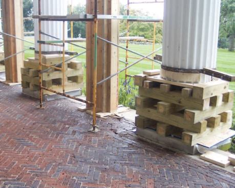 After cutting away the bases, the crew placed cribbing under the shafts while awaiting the delivery of new columns.