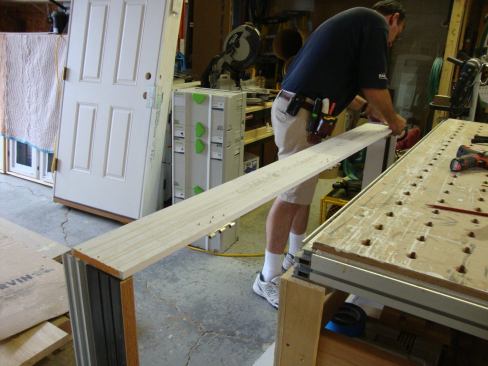Greg places the rabbets in the side jamb over the top and bottom jambs and makes sure they are aligned before driving the screws.