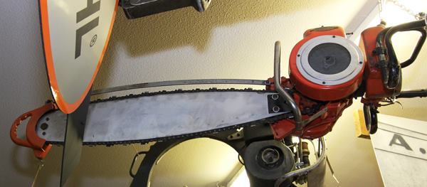 In the early days chainsaw bars had some belly to them; chains tended to sag off the bar and the belly helped them maintain contact. It was also thought to fling chips and debris off of the chain. The belly went away after rollers and sprocket tip guide bars hit the market in the 1950s and early 1960s. This particular saw was made by Reed-Prentice in Massachusetts.