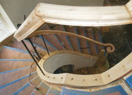 The bar balusters, which go in deeper holes and reinforce the balustrade, get fitted first. Because of the curb's steep rake angle, the bottoms of the balusters can't be finished with rake shoes.