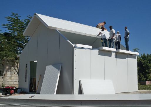 A pair of 8-foot ladders was the only lifting equipment on site. Fortunately, even the 24-foot-long 6-inch roof panels were light enough to be hoisted into place by hand.