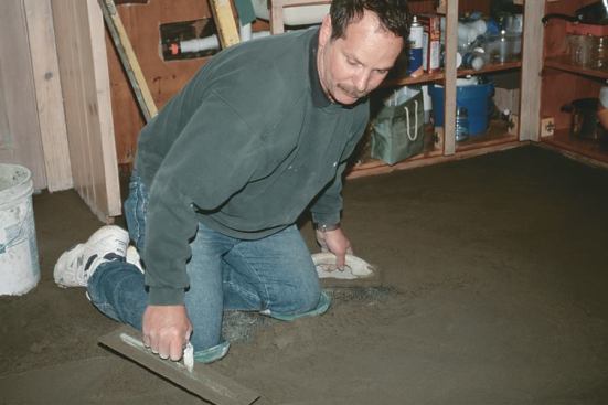 The mud is packed and floated in one two-fisted action: A wood trowel levels and fills the base, followed by a steel float for a smooth finish.