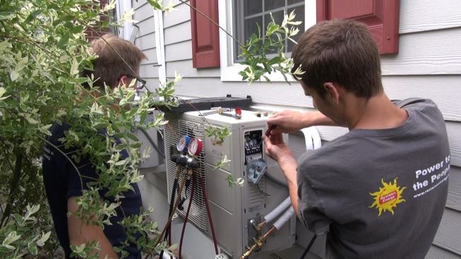 While the electrical crew is installing the photovoltaic array and running conduit, two more ReVision technicians are installing the twin Fujitsu heat pumps that will use the power provided by the PV panels. Here, Dave Ragsdale purges and pressure-tests the system’s refrigerant lines and Andy Melrose connects the compressor to power.