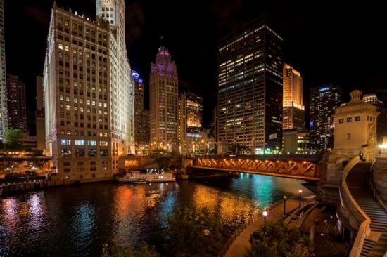 A night view looking across the Chicago River toward the neo-Gothic Tribune Tower, another iconic Chicago landmark.