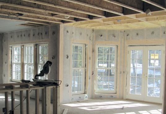 Dense-pack cellulose insulation was blown behind a permeable membrane stapled to the studs.