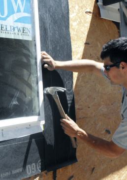 I drive 2-inch galvanized nails into the center of every other nail hole in the bottom and side flanges.