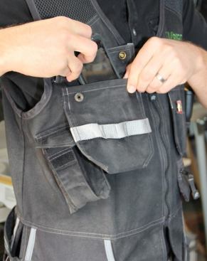 I keep my phone in the large chest pocket with the flap that snaps. Notice how the bottoms of the chest pockets are not sewn tight to the vest; this allows them to swing out when you bend over, so the contents are less likely to fall out (the same is true of the chest pockets on the left side of the vest). The loops on the right chest pocket can be used like the ones on the lower pocket – to keep screwdrivers and small pliers at the ready.
